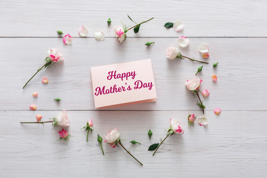 Happy mothers day background, card and flowers on white wood