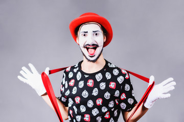 cheerful mime posing and grimacing in the studio