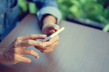 close up hand hold mobile cell phone device:focus on man text on smart phone concept