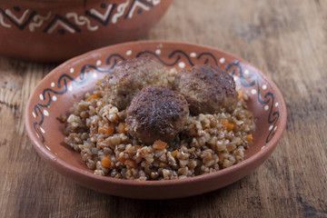 Meatballs with buckwheat porridge in a clay dish