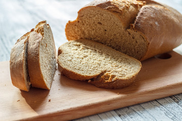 On a wooden background rye bread sliced close-up.