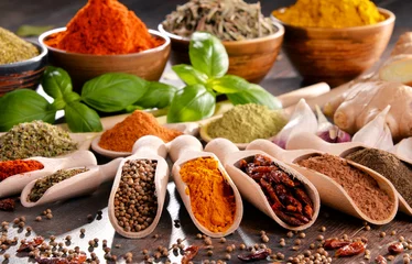 Fotobehang Aroma Variety of spices and herbs on kitchen table