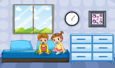 Boy and girl toddlers on blue bed