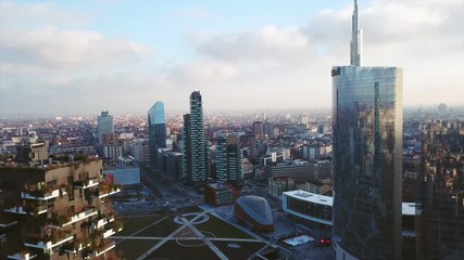 Aerial footage shooting with drone on Milan skyline and vertical forest (bosco verticale) at sunset - Powered by Adobe