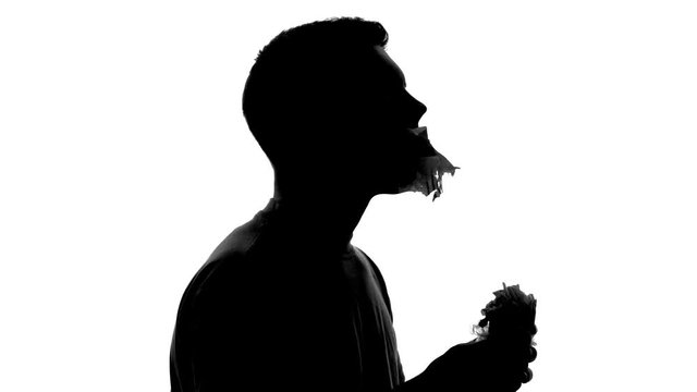 Hungry man silhouette with huge appetite biting and chewing greasy fast food