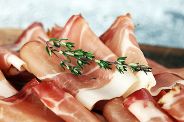 Italian prosciutto crudo or jamon with parsley. Raw ham