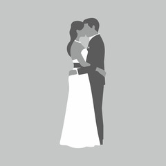  A groom and fiancee kiss each other on gray background