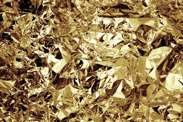 Gold colored crushed foil textured background