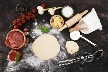 Fototapeta na wymiar Fresh original Italian raw pizza preparation with fresh ingredients