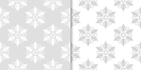 Light gray floral backgrounds. Set of seamless patterns