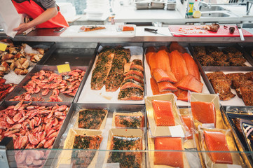 Large showcase with shrimp fish and seafood delicacies on the counter of the Norwegian fish market.