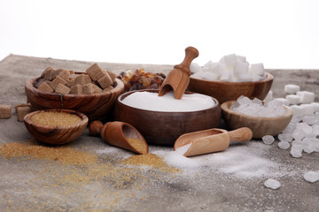 Various types of sugar, brown sugar and white on table