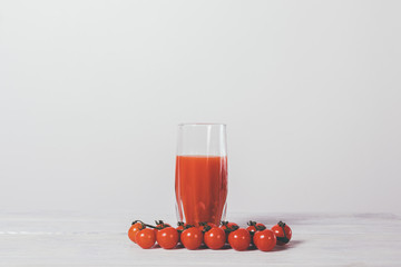 Tomatoes and fresh juice in a glass