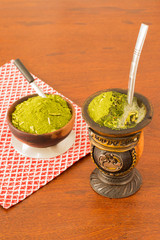 Mate or chimarrao its a traditional drink from South America drink in a calabash (gourd) with yerba mate drink, top view, freshly made, hot ethnic drink.