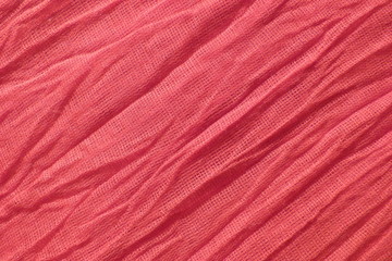Fototapeta na wymiar red natural fabric close-up background for decoration backdrop cotton ribbon coarse cloth scarlet color crumpled fabric abstract pattern texture pink silk