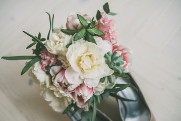 wedding bouquet of flowers and wedding shoes