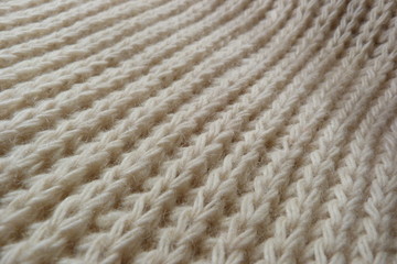 knitted scarf close-up beige knitted fabric yarn wool acrylic cotton natural thread close-knit vintage background for decoration hand-made background made by hand