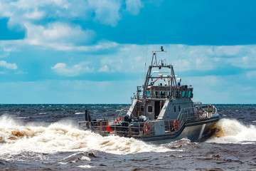 Grey military ship at sea