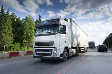 Fototapeta na wymiar Truck on road, blue sky, cargo transportation concept