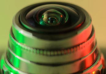 Fototapeta na wymiar Close-up camera lens with green-red illumination. Horizontal photo.