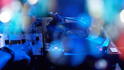 Fototapeta na wymiar Closeup of a DJ keypad with vinyl records.
