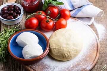 Making pizza. Pizza dough with ingredients