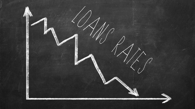 Loans rate. Declining Line graph drawn with chalk on blackboard