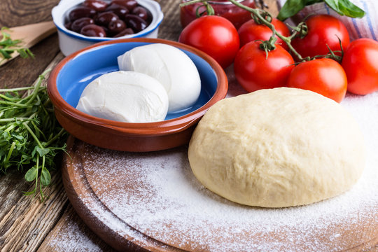Making pizza. Pizza dough with ingredients