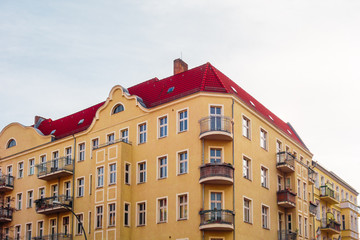 Fototapeta premium orange residential corner building with copy space in the sky