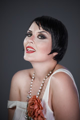Luxury, Brunette girl with short hair, French mane in the style of the 20s. She wears white fur...