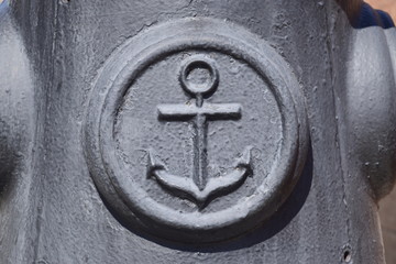 Icon of the sea anchor on the concrete. Symbol of seamen