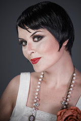 Luxury, Brunette girl with short hair, French mane in the style of the 20s. She wears white fur...