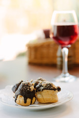 Dessert beverage with the chocolate at the top and glass of red wine.