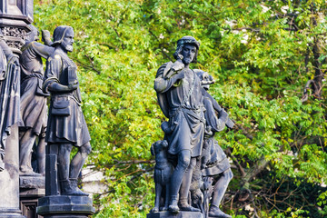 Sculpture or Statue of a men hunters with gun and dog in the park