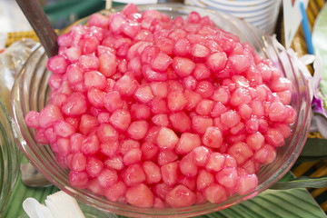 Crispy ruby for coconut milk, Tab Tim Grob, Mock Pomegranate in Coconut Syrup. Thai dessert Crispy Ruby in Market,Thai desserts Pretty red background.