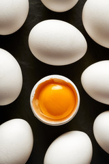 Chicken eggs with white shells on a black background. Black and white concept