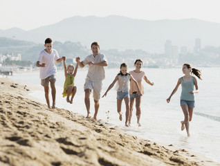 Big family running on beach