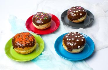 Donuts on colorful plates top view
