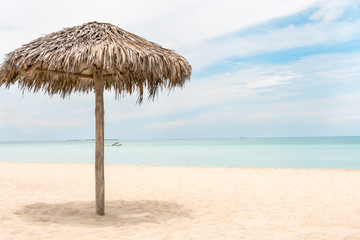 Fototapeta na wymiar foreground - Palm tree umbrella & background tropical sky &