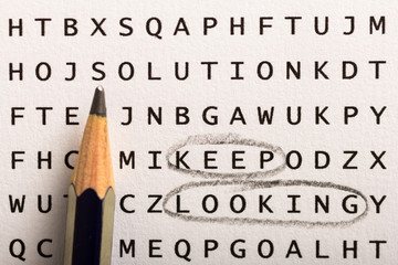 Word search, puzzle. Concept about finding, keep looking, persistence. Pencil pointing to unmarked word: Solution © Vergani Fotografia