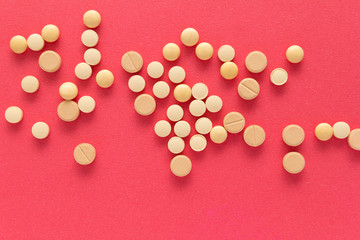 Heap of pills spreaded over color table. Group of assorted beige tablets.