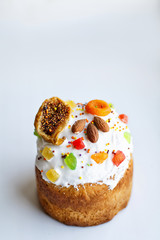 Easter cake with figs, dried apricots and almond on light background.