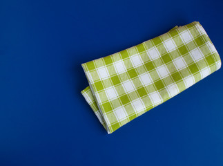 Green checked tablecloth on blue background
