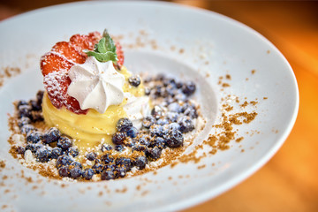 Dessert Anna Pavlova on a plate in a restaurant