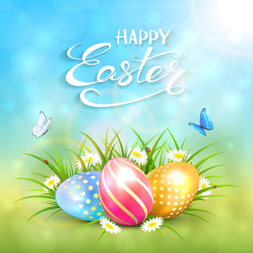 Blue sunny background with Easter eggs in grass