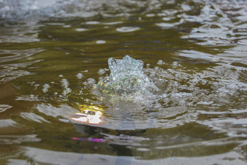 Small urban fountain with multi-colored electric lighting.