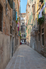 One of the many streets of Venice with many cafes, shops, tourists, Italy. Venice is a popular tourist destination of Europe.