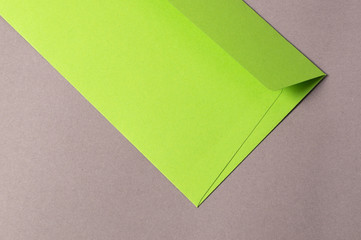 Green envelope on the grey background with copy space for your message