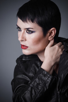 Haircut, Brunette woman dressed in leather jacket, androgynous appearance, beauty and short hair