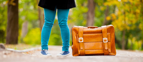 Teenager foots with suitcase